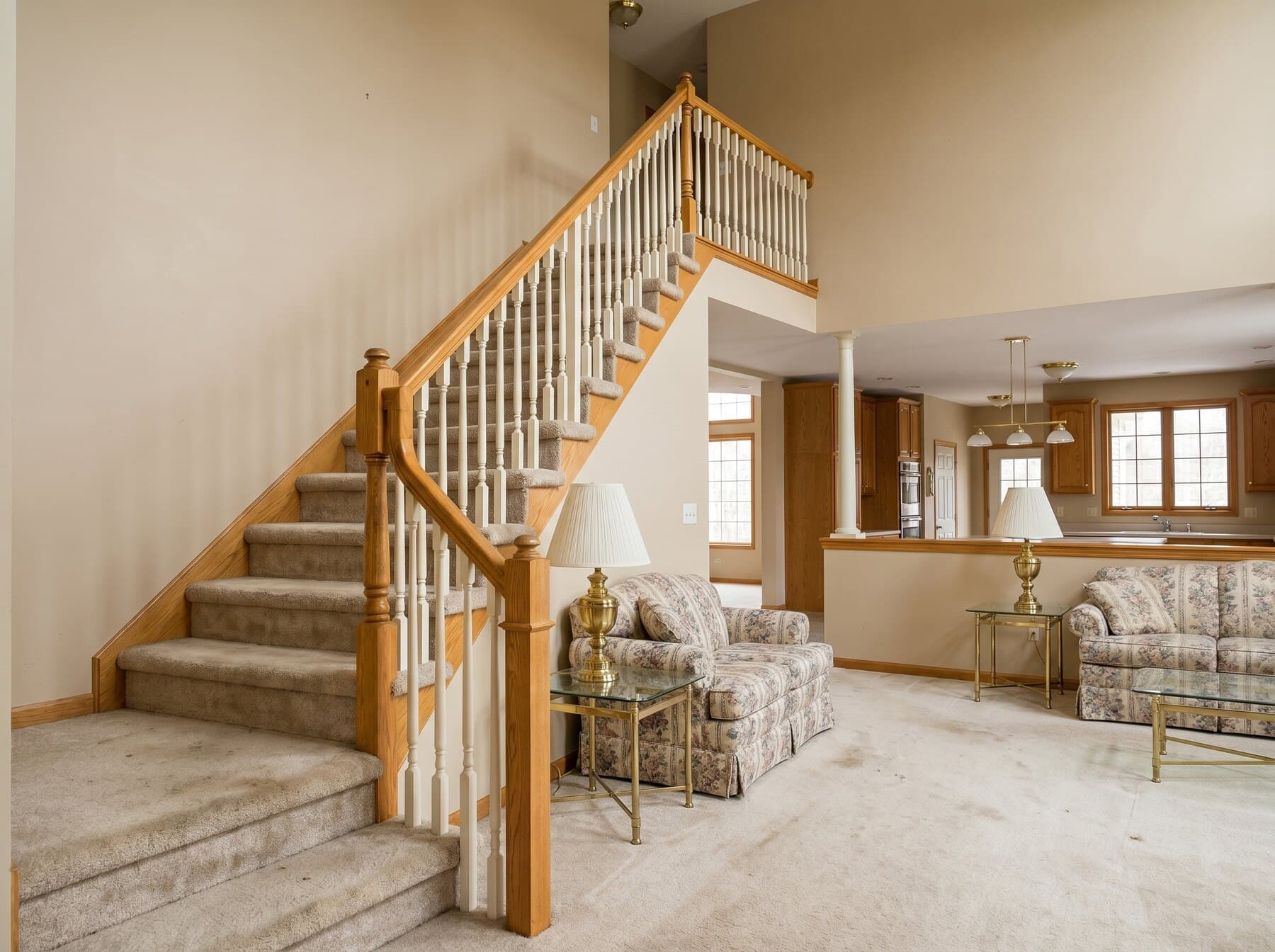 Center Valley staircase before the remodel — dated carpeted treads and tired wood spindles