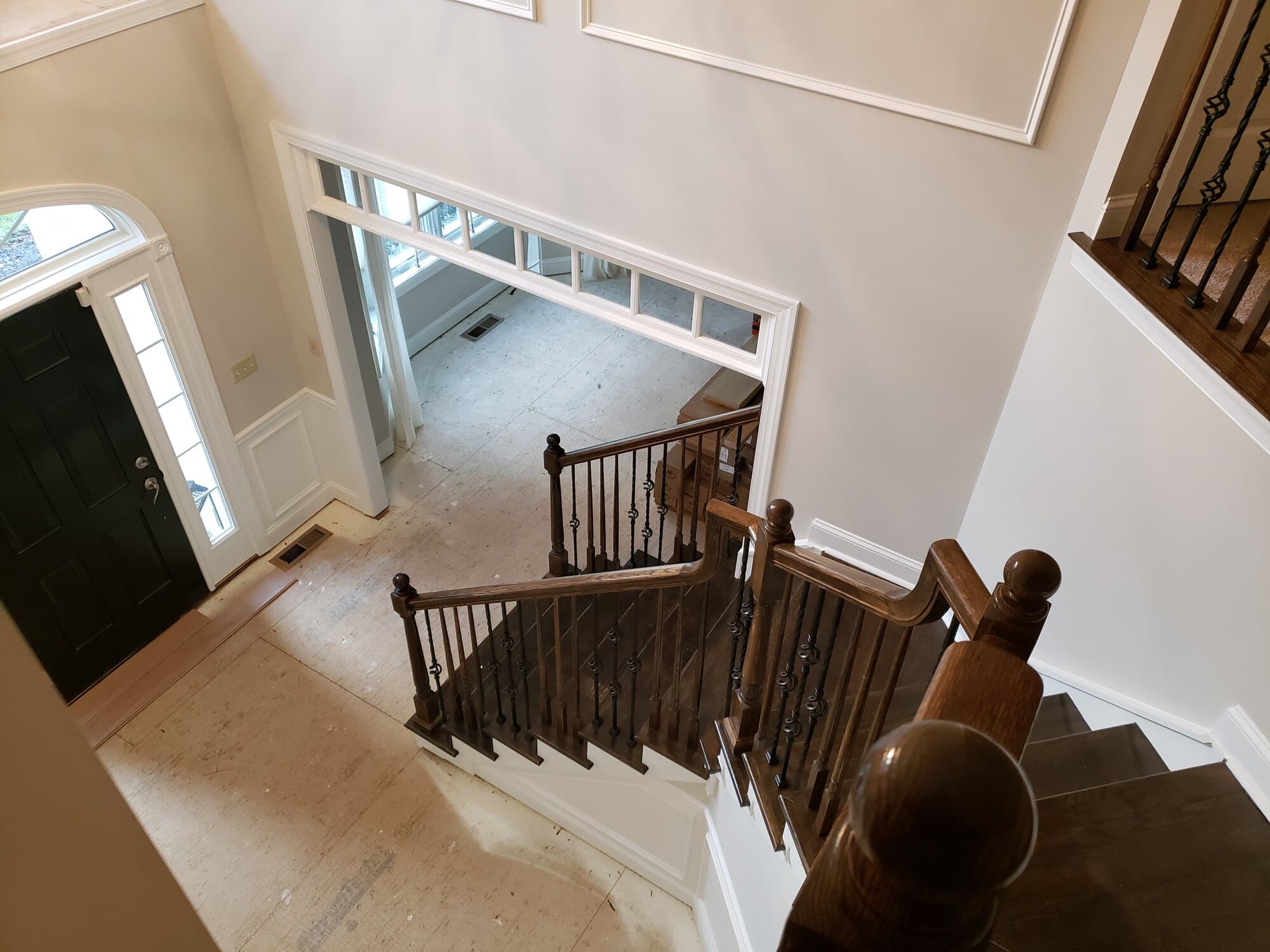 Dark-stained oak railing with ornate basket-twist iron before Snyder rebuilt it — Modern White Oak stair