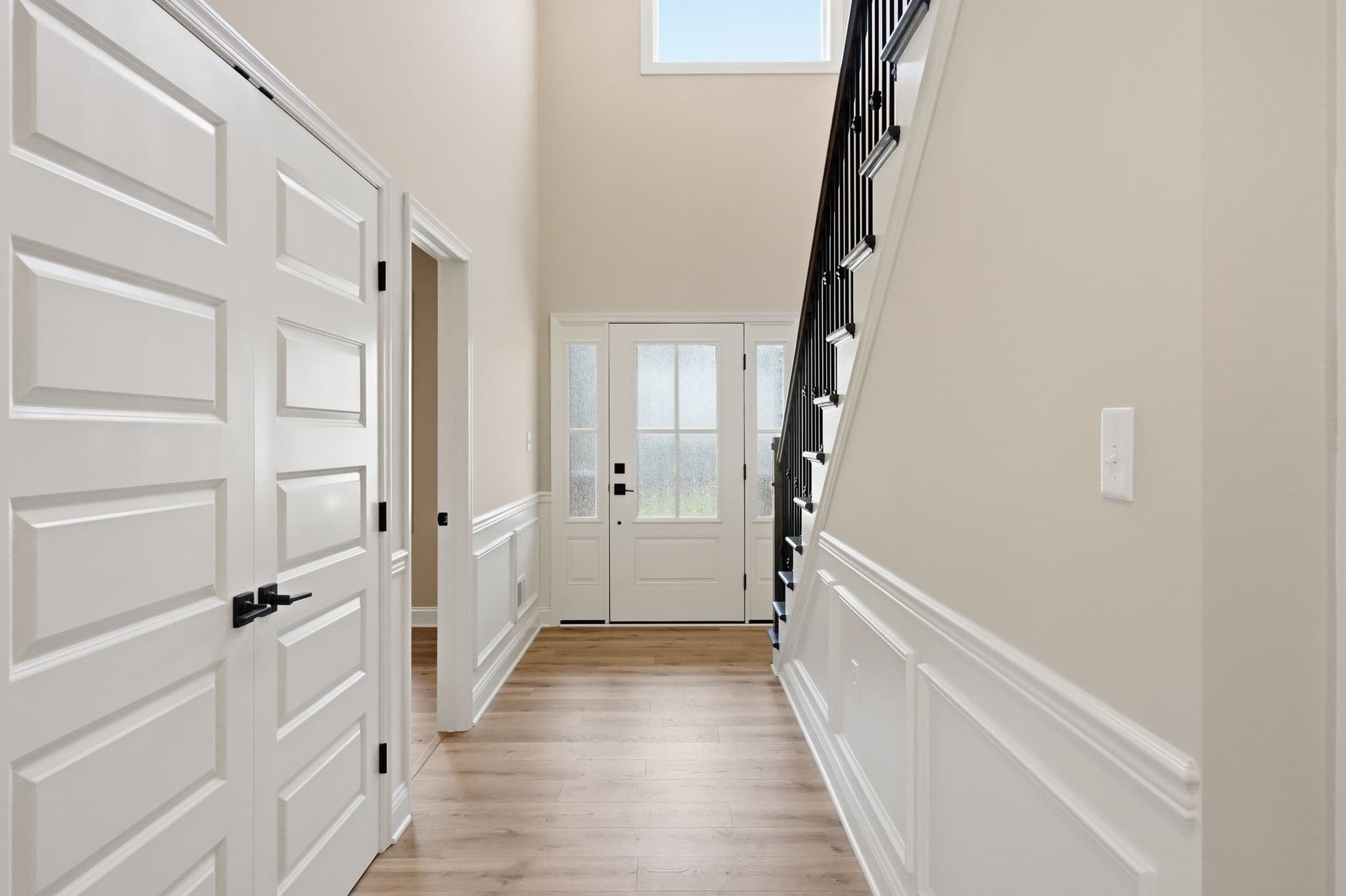 Snyder Stairs finished install — entry foyer with iron balusters, recent project