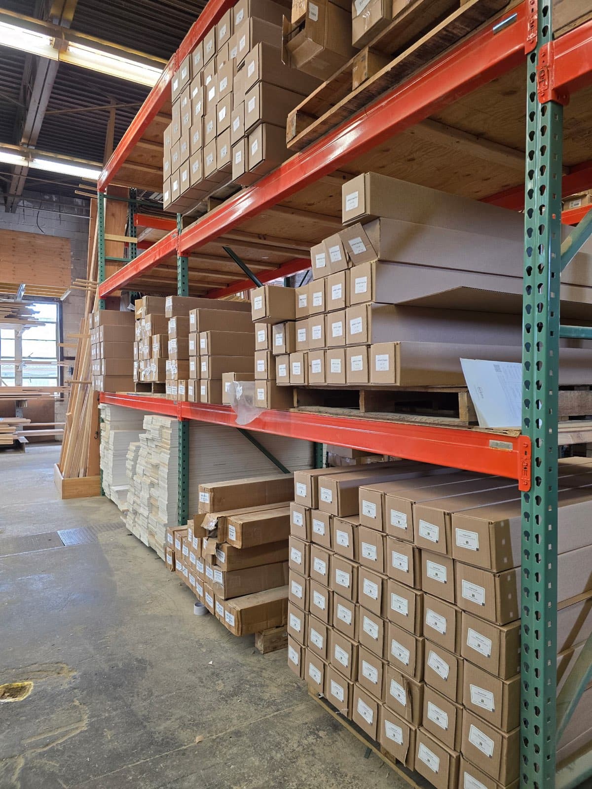 Stair components staged on pallets, crated for delivery against the framing date.