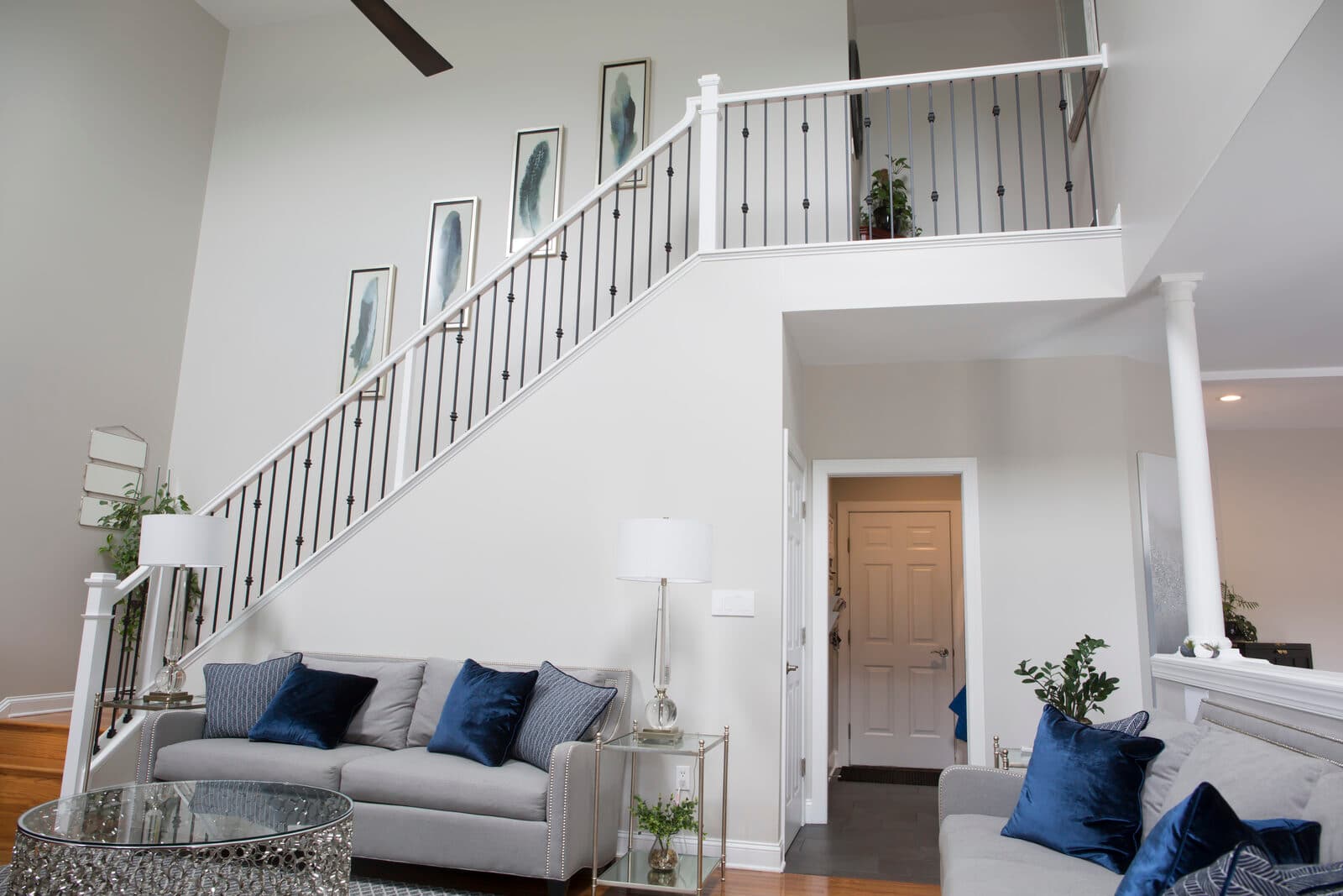 Black iron balusters on a finished balcony rail overlooking the living room — Lehigh Valley install
