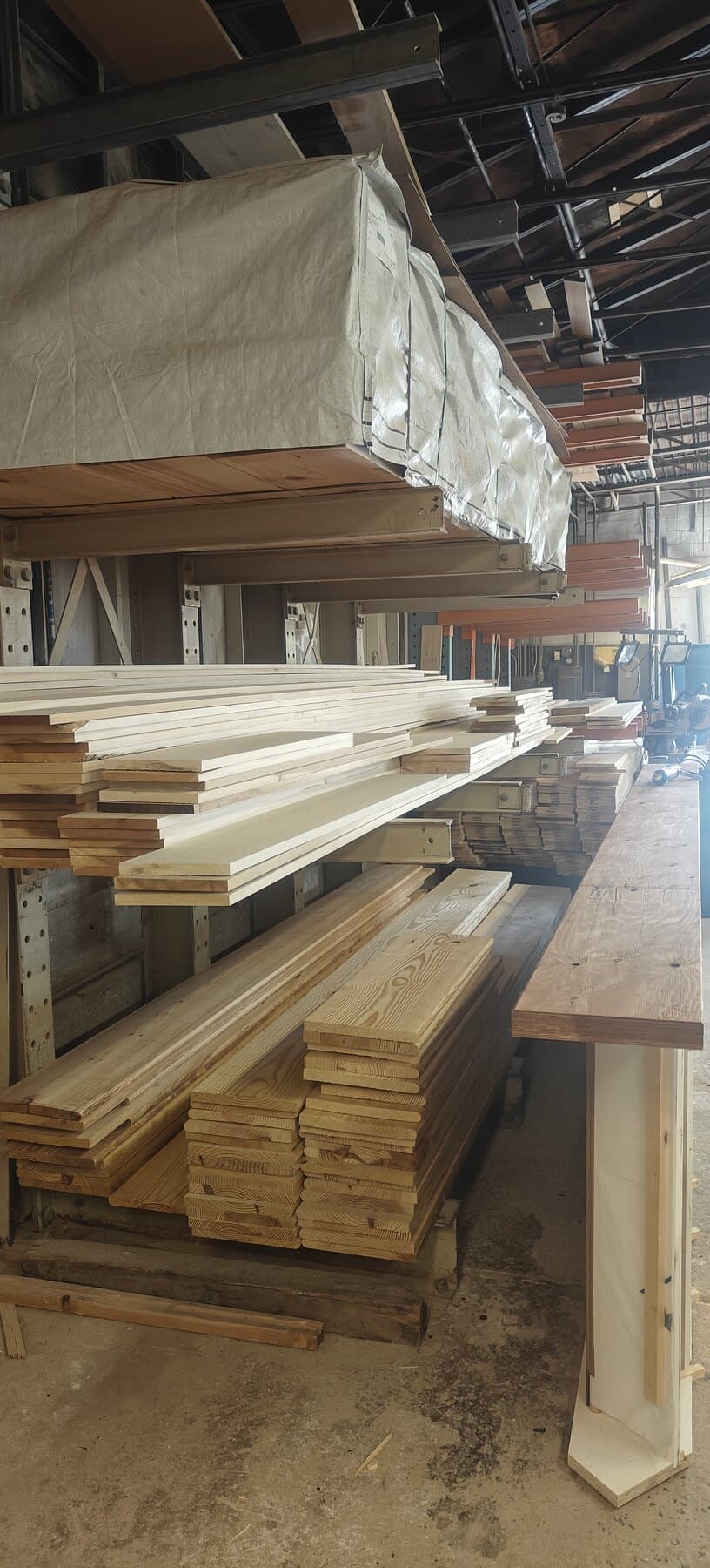 Snyder Stairs lumber library — hardwood boards racked in the Whitehall shop (Feedbucket 926982)