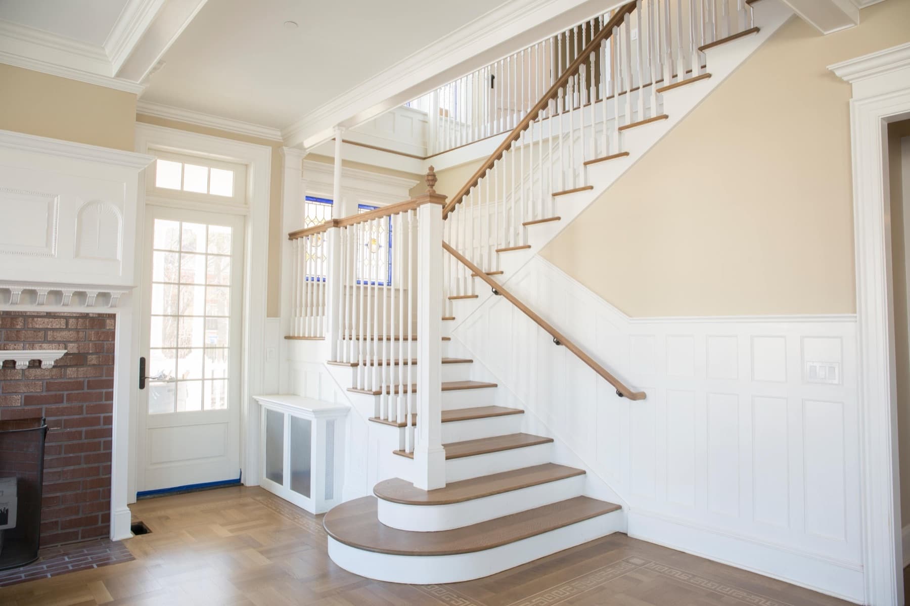 New wood treads and white risers after the floor-matched tread replacement — a Lehigh Valley foyer