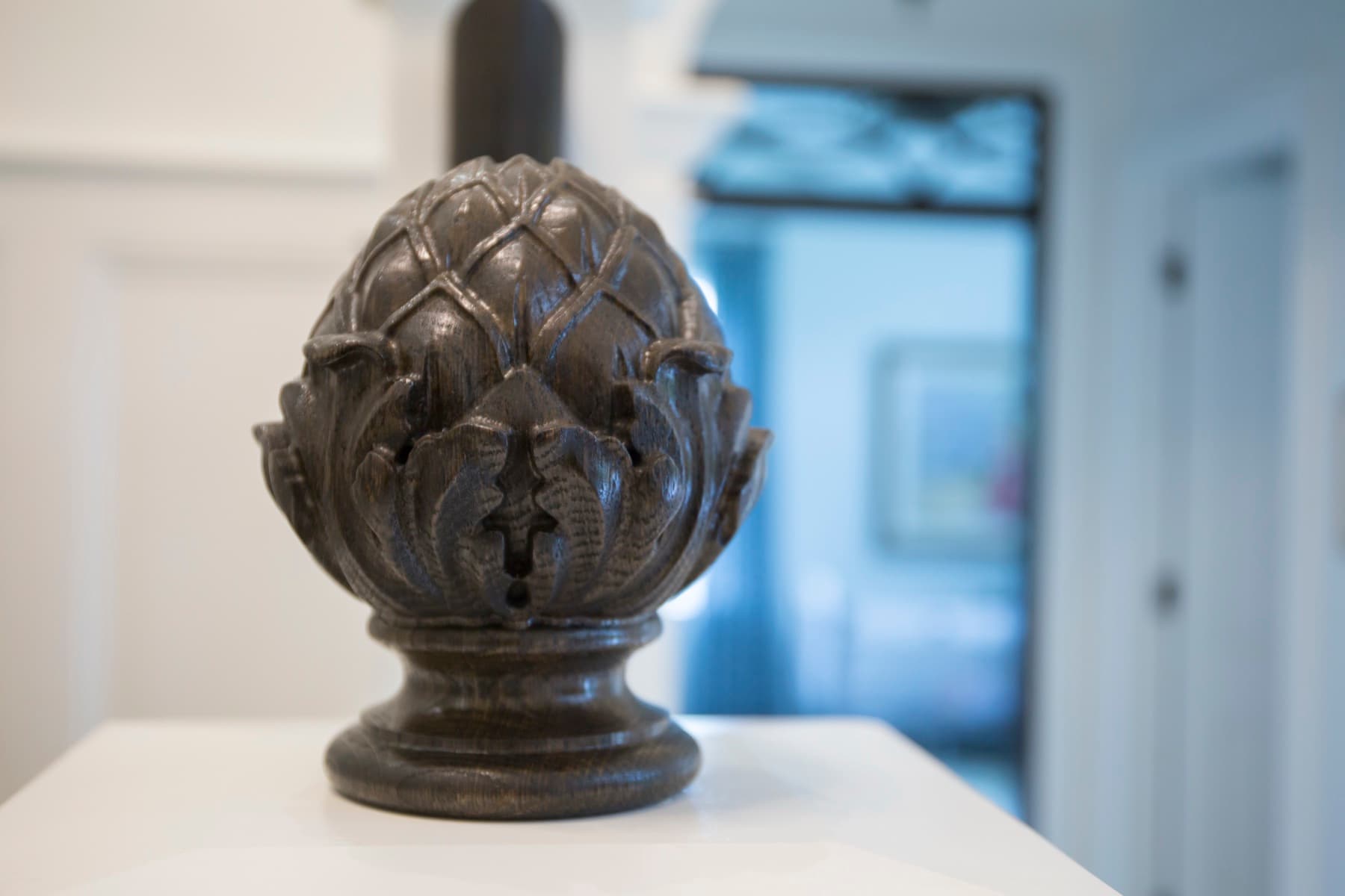 A carved acorn newel finial — the kind of period part we measure and match.