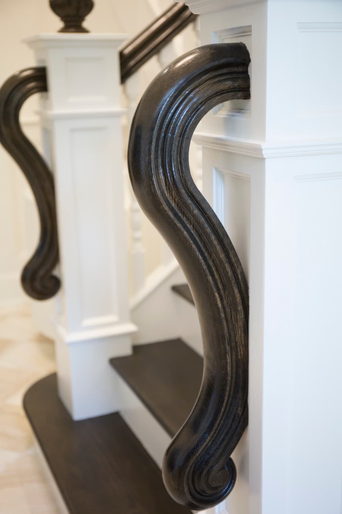 Caruso staircase from the second-floor landing — wide tread detail