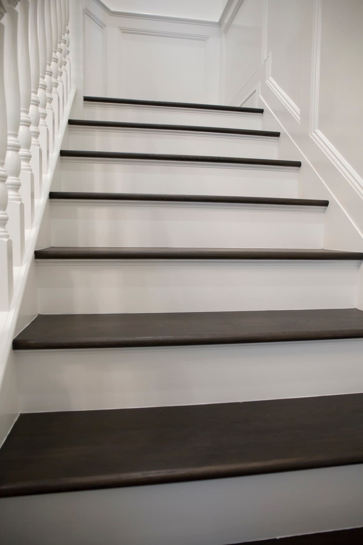 New wood treads with white painted risers, matched to the home's flooring