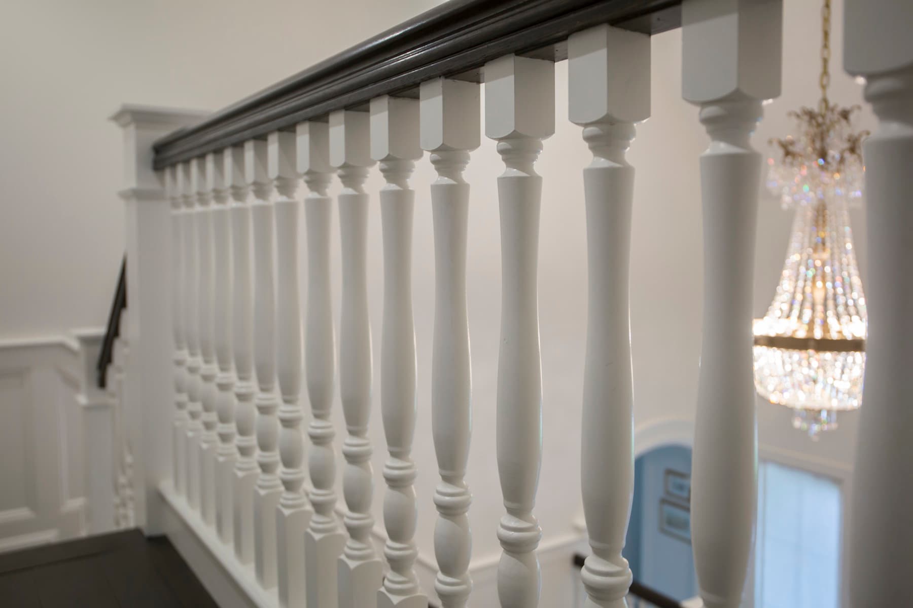Wood balusters and a shaped handrail at the upper landing — Caruso residence