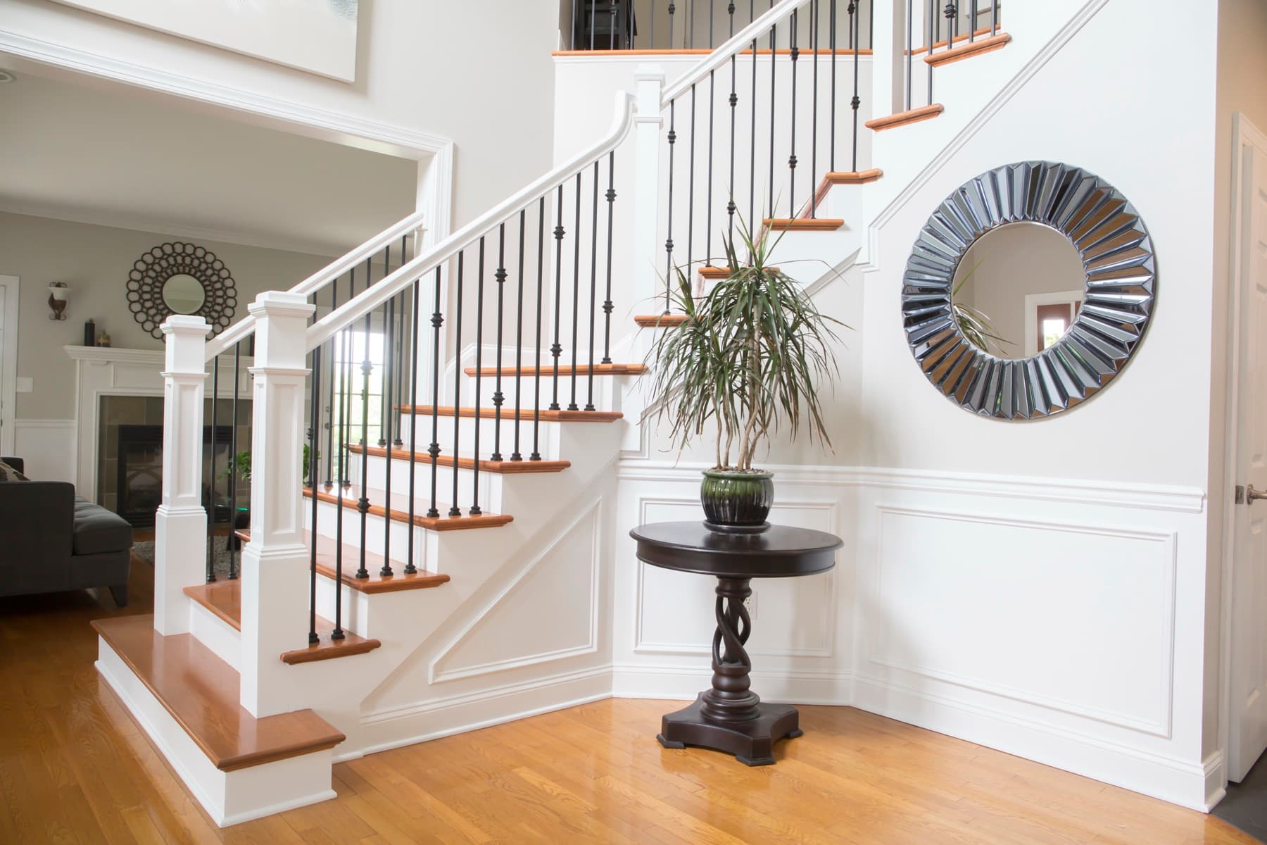 Satin-black iron balusters with oak treads on a Center Valley foyer stair