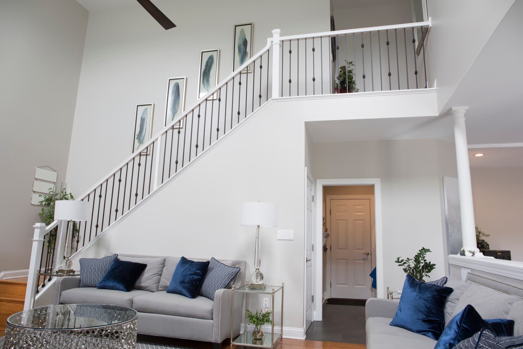 Black iron balusters with a white handrail on a finished foyer stair — Lehigh Valley iron baluster swap