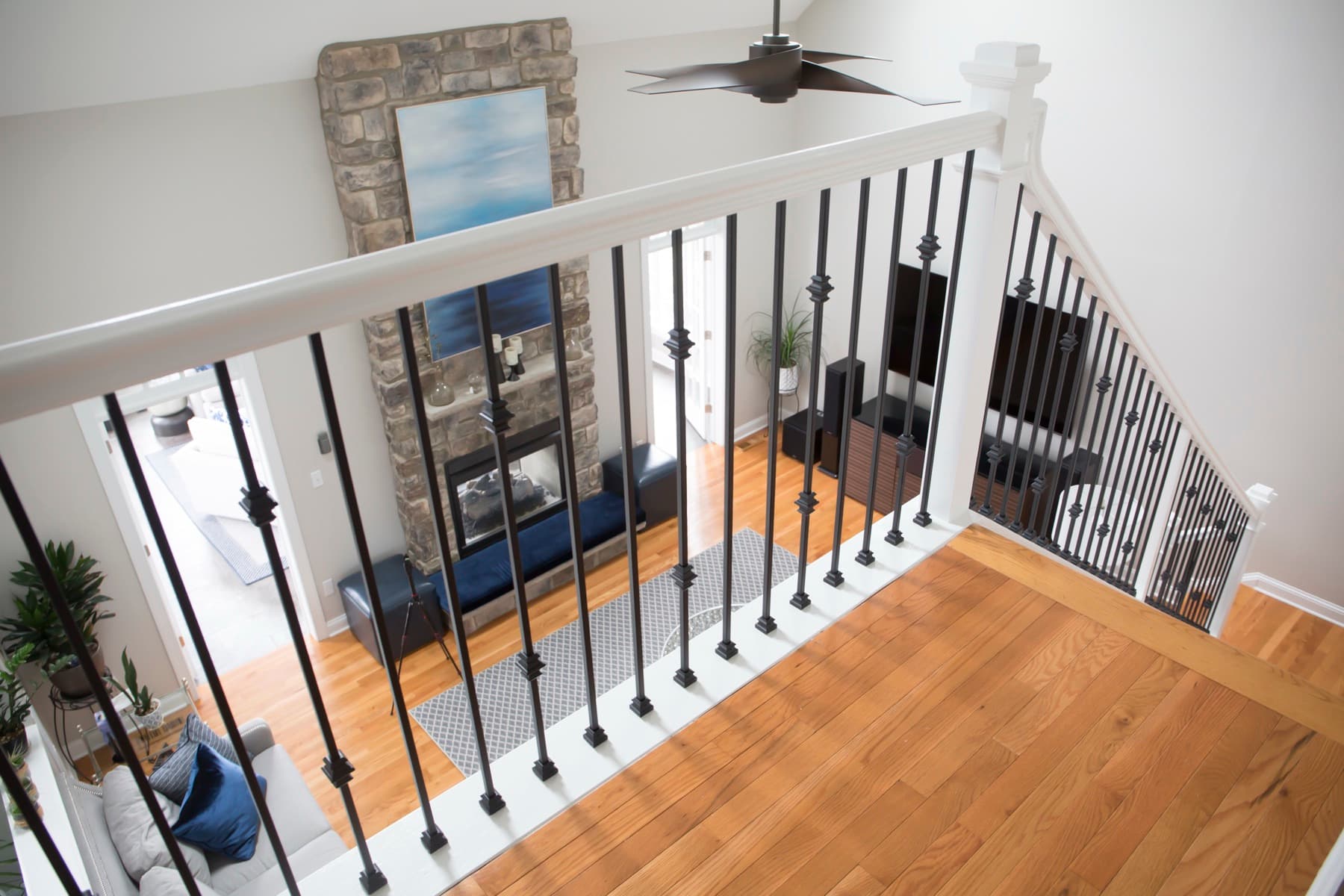 White oak treads and landing with iron balusters — Center Valley residence