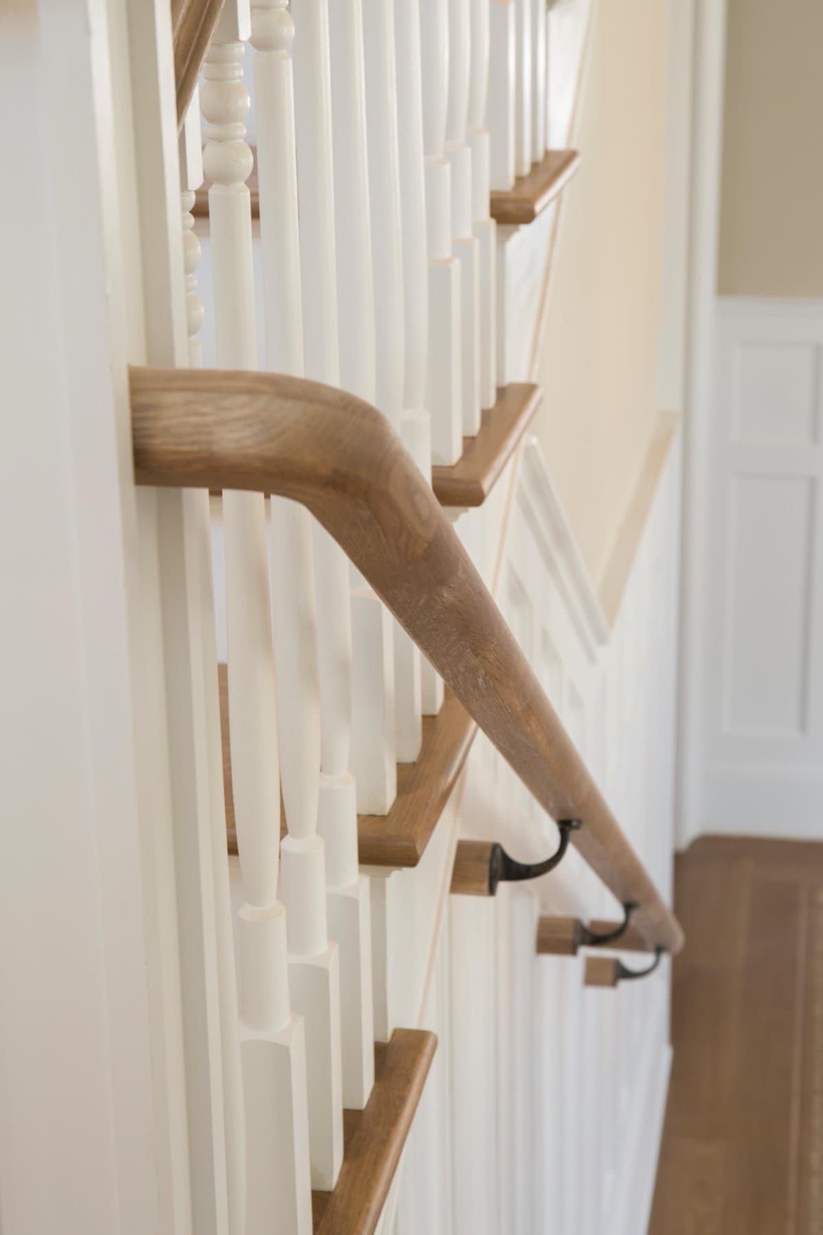 Oak treads and stained oak handrail with turned white balusters — Faucett period restoration, Hackettstown NJ