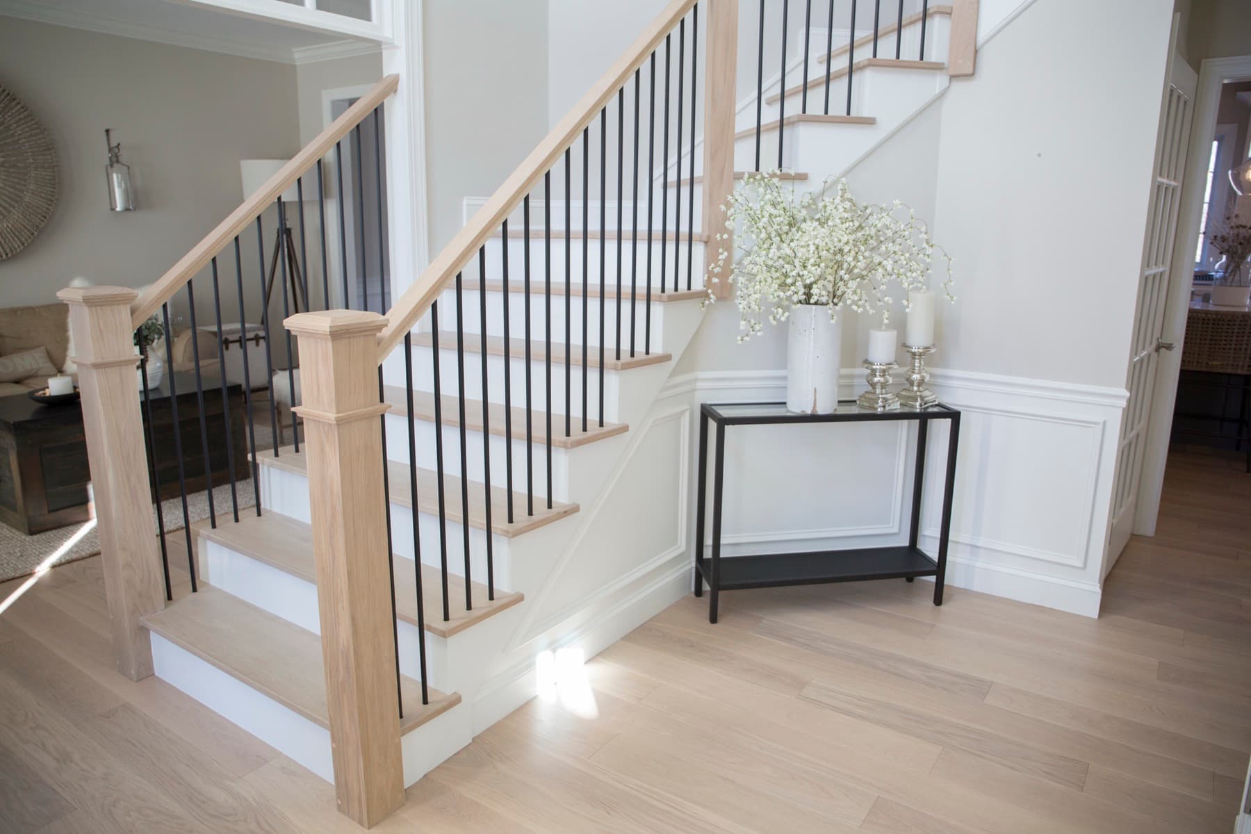 White-oak treads with slim satin-black iron balusters after the remodel — Modern White Oak, Lehigh Valley
