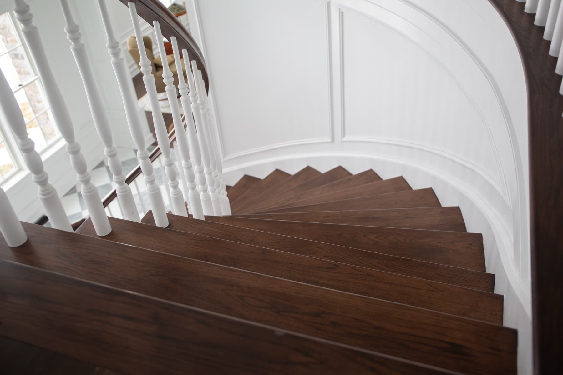 Continuous wood handrail over turned balusters wrapping a foyer — Lehigh Valley railing system