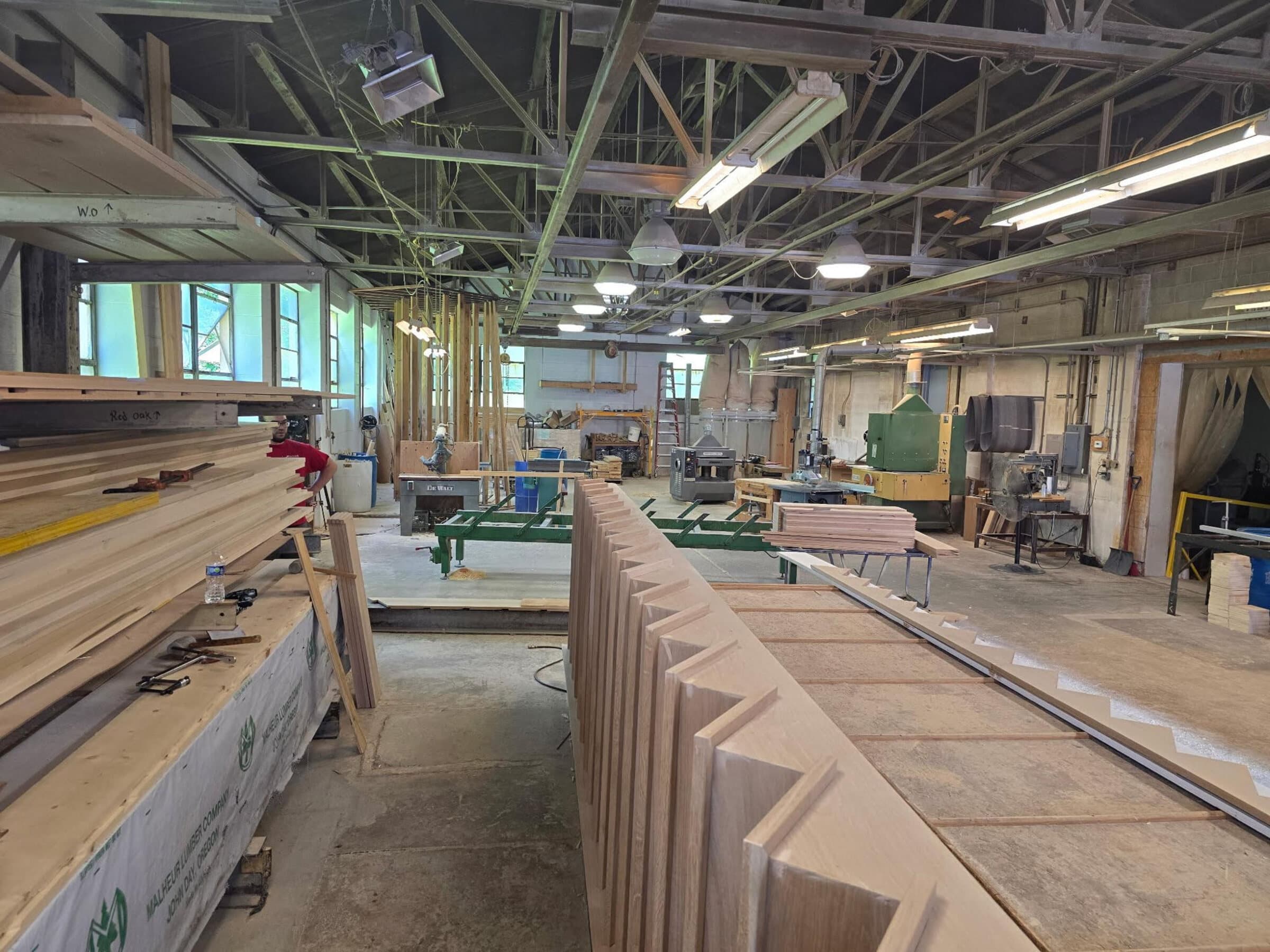 Snyder Stairs Whitehall shop floor — a worker among stair stringers at 117 Franklin Street